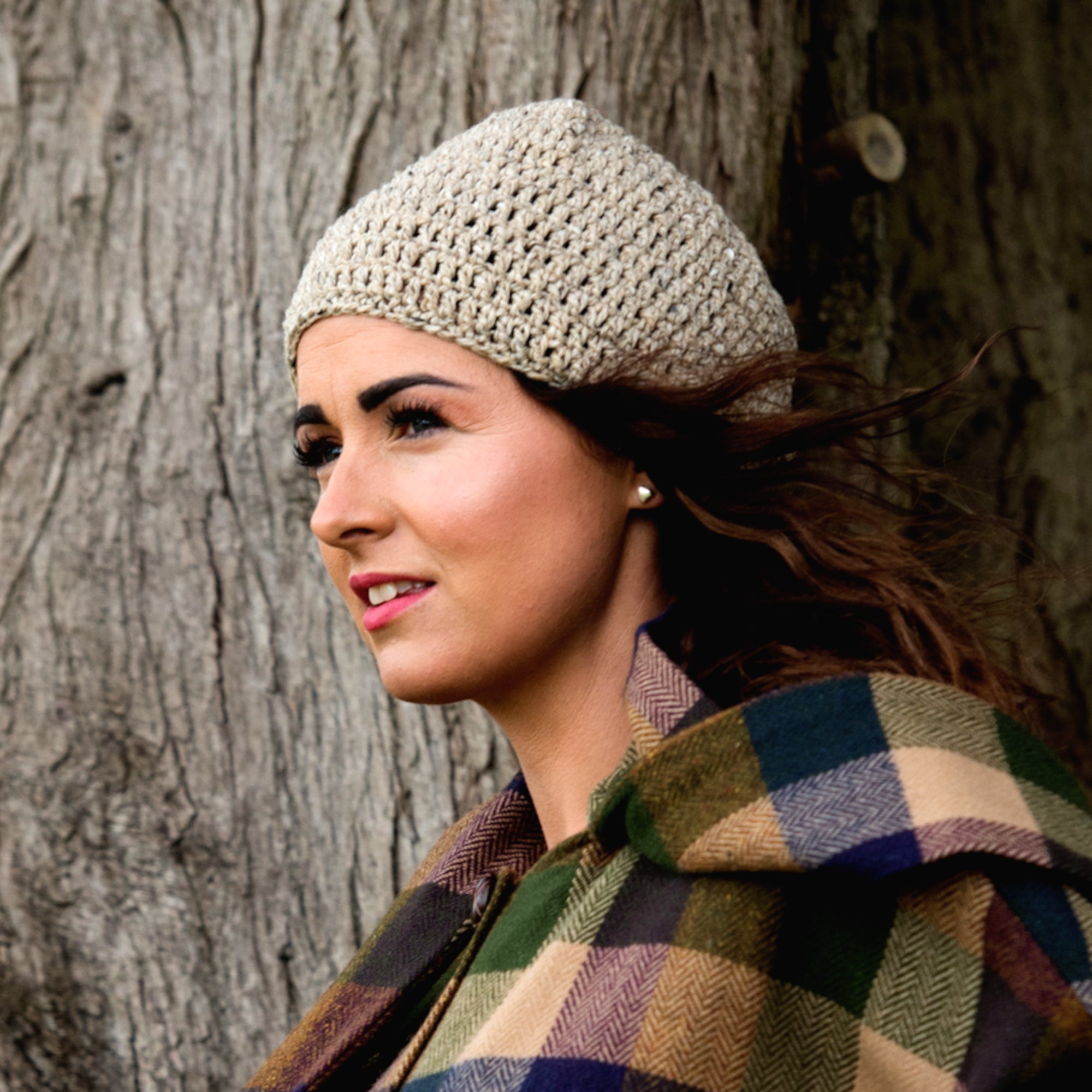 Woman wearing hand knitted Donegal yarn hat with Donegal Tweed cape
