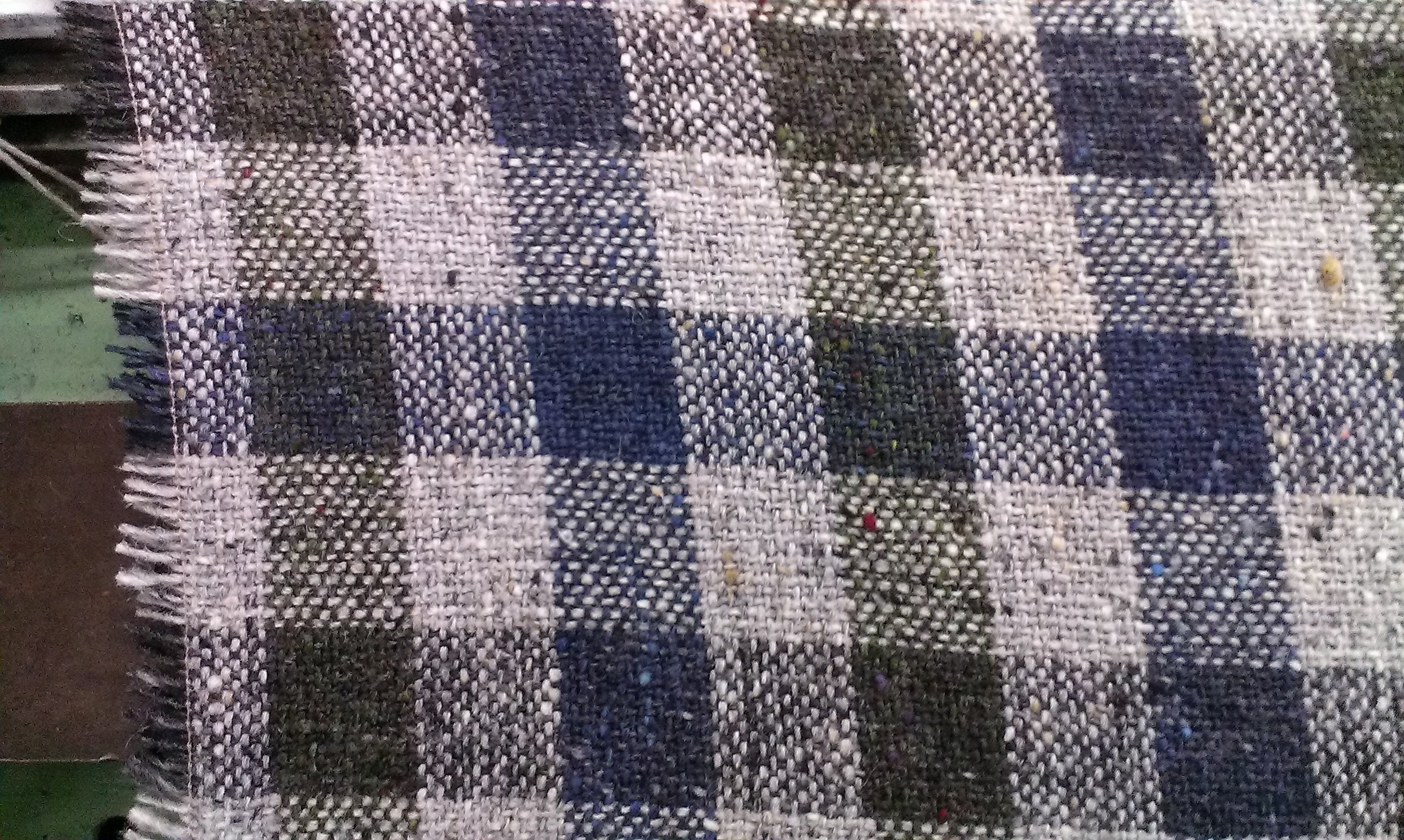 Signature Check Donegal tweed fabric close up showing colourful flecks and check pattern woven in County Donegal, Ireland